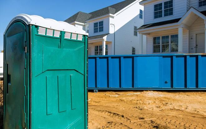 portable toilet and dumpster at a construction site in Lehi UT